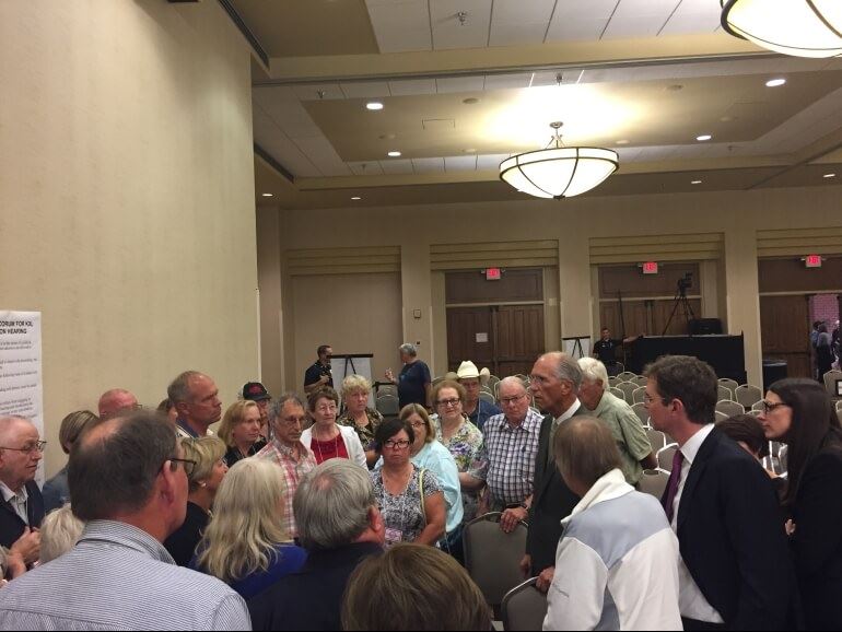 Dave Domina and Brian Jorde talk with a group of landowners at the end of a day in trial before the Public Service Commission in August 2017 at Lincoln NE.